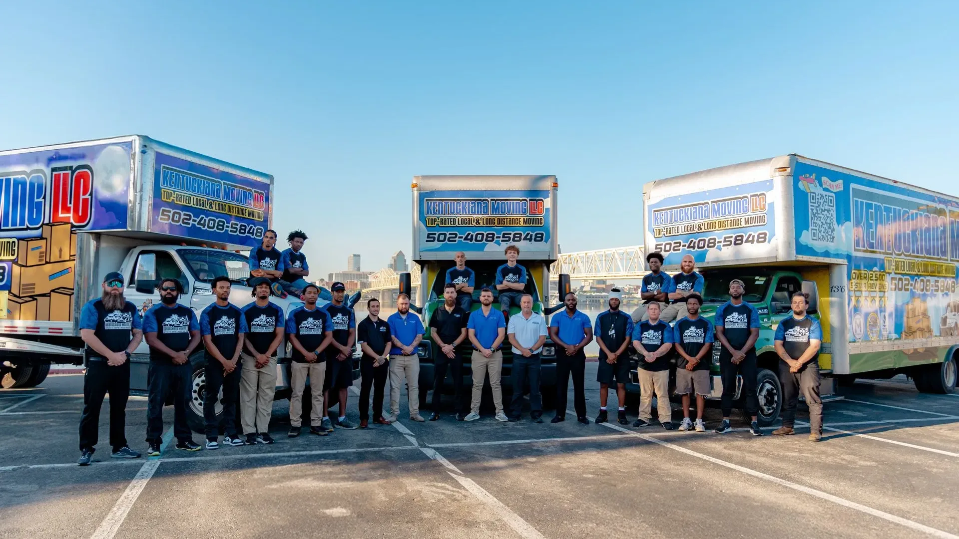 Kentuckiana Moving team standing with branded moving trucks